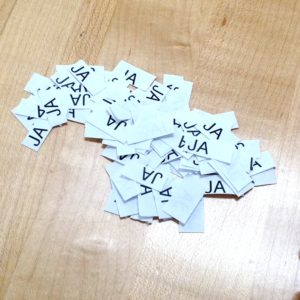 Pieces of paper reading "Ja"